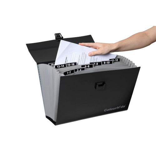 Hand placing a sheet into the opened ColourHide carry file, grey pockets tabbed with printed number labels