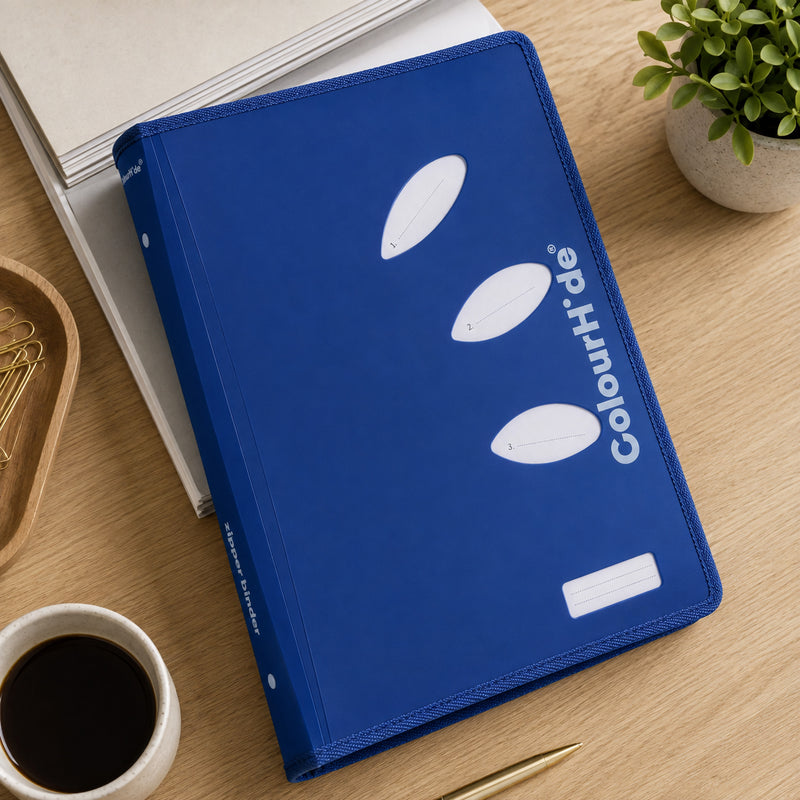 Illustrative desk scene from our earlier listing: a blue zipper binder lying on a desk next to a coffee cup