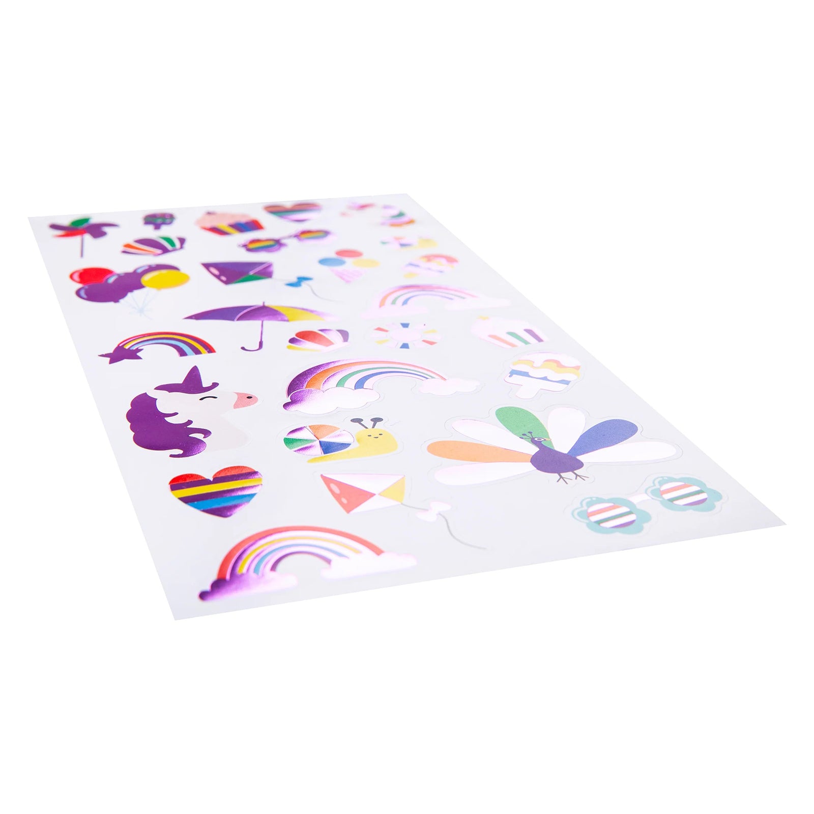 Angled view of the complete Colours of Joy foil sticker sheet displaying reflective rainbow themed illustrations. The foil accents catch the light across unicorns, balloons, peacocks and decorative motifs, showcasing the premium finish of the sticker collection.