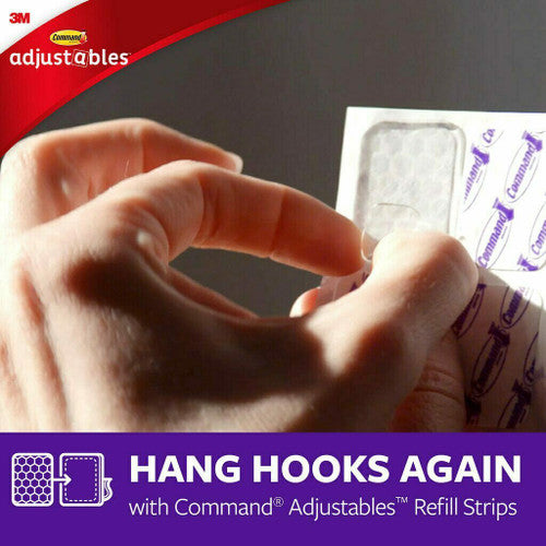 Command Adjustables hooks displayed on a home office wall organising cables