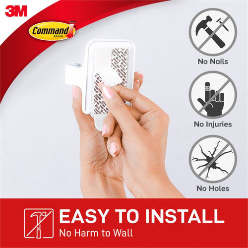 Command Broom Gripper installed in a laundry room organising cleaning tools