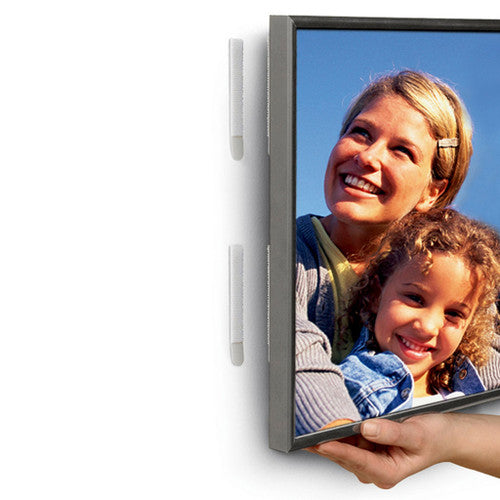 Command strips applied to the back of a photo frame ready for hanging