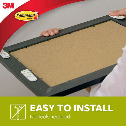 Hand pulling Command strip tab straight down for clean removal from wall