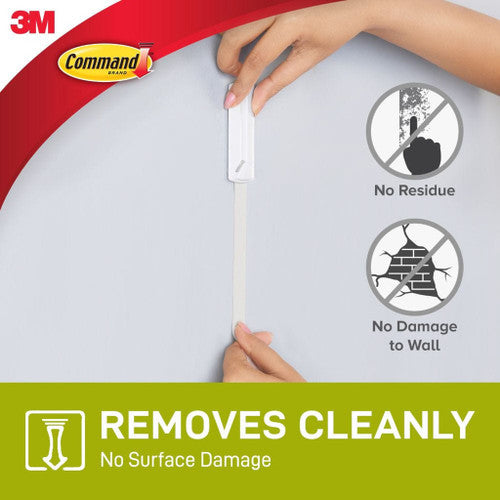 Rear view of adhesive strip applied to smooth indoor wall surface