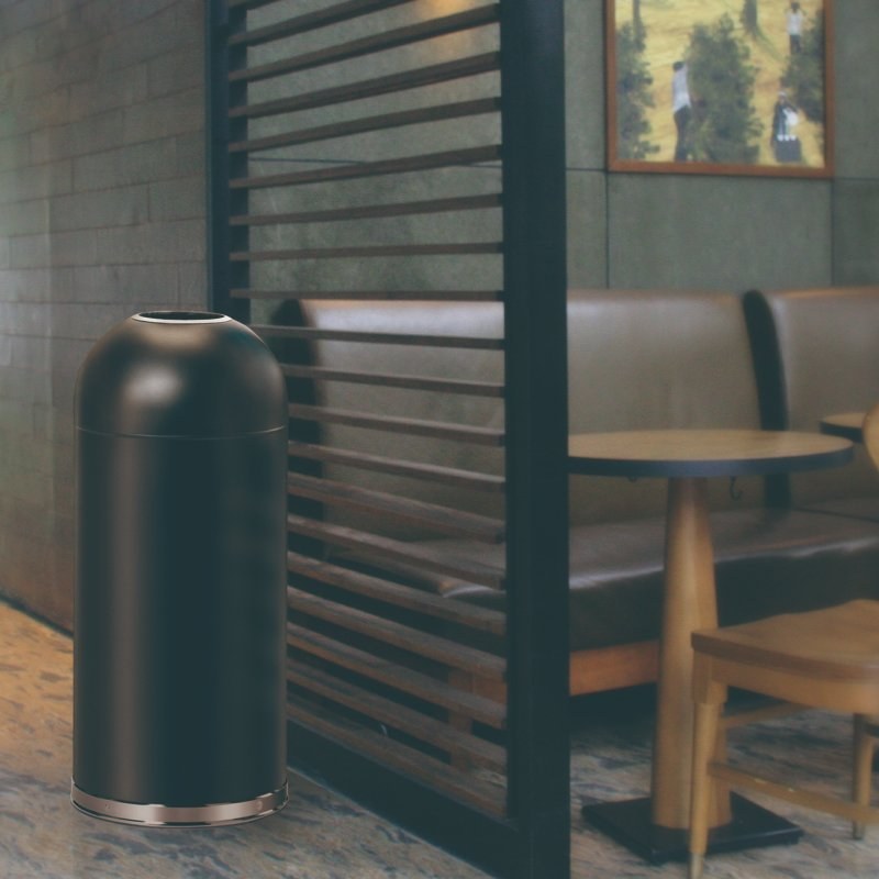 Compass black bullet bin standing beside slatted timber screens and booth seating in a cafe setting