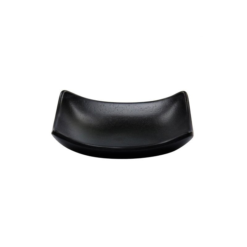 Compass curved black melamine soap dish with a speckled stoney grain finish, two edges sweeping upward, seen from a low front angle
