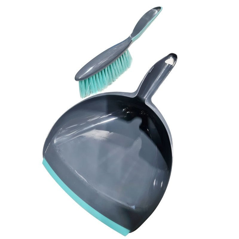 The Compass dustpan and brush shown apart, the grey handled brush with aqua bristles held above the dark grey pan and its aqua edge