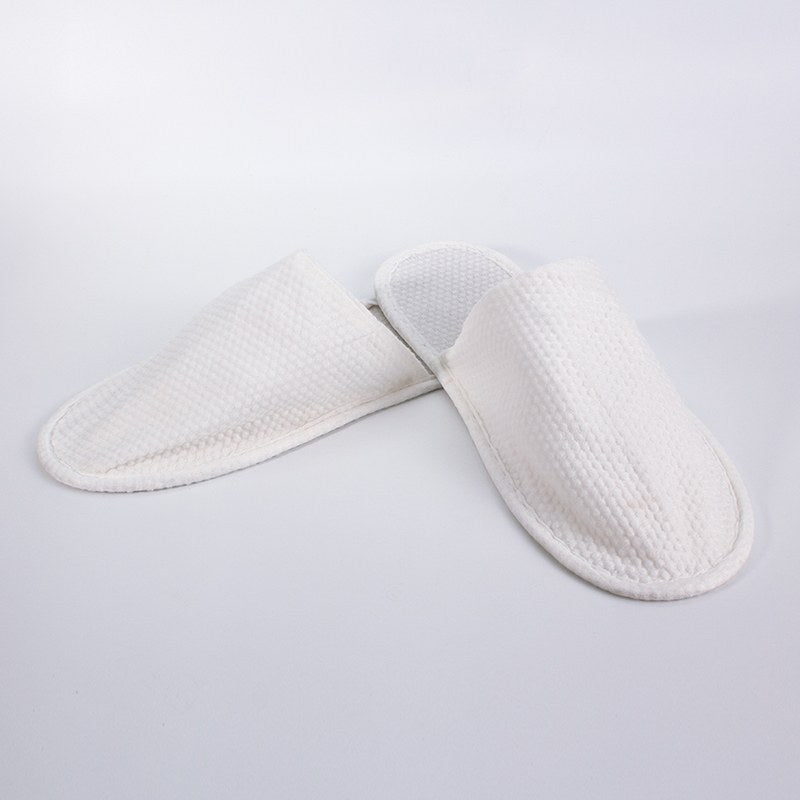 Pair of Compass white closed toe Eco Slippers side by side at an angle, the honeycomb textured upper covering the toes
