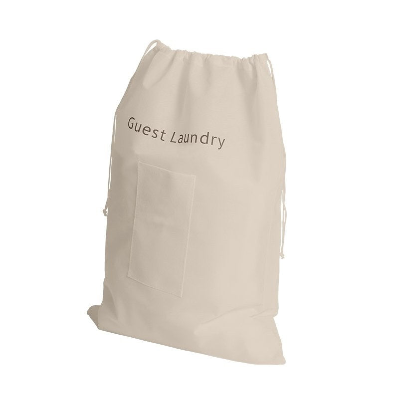 Compass natural oatmeal non-woven laundry bag printed Guest Laundry, with a stitched front pocket and a white drawstring at the neck