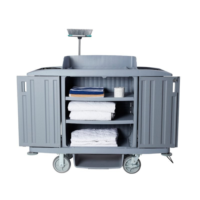 Compass 722472 trolley with both doors folded back, showing three shelves stocked with towels, linen and toilet rolls, broom on a pole above