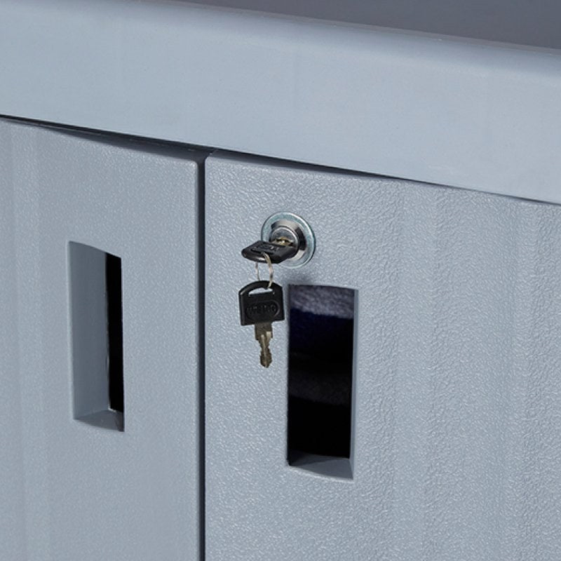 Close-up of the Compass 722472 trolley door lock with a pair of keys in it, beside the moulded door handle