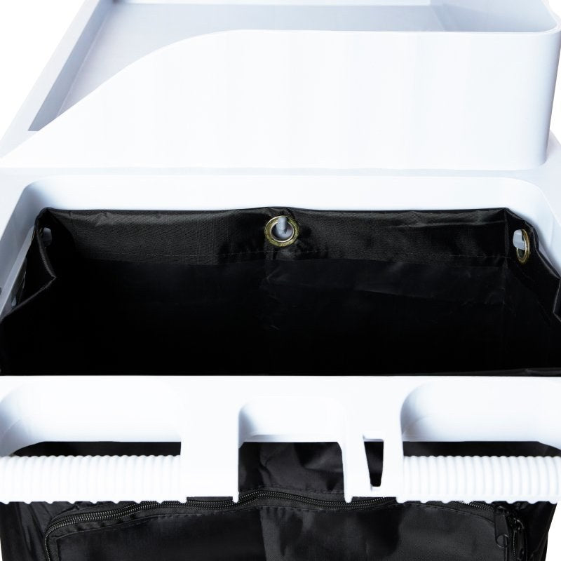 Close-up of the top edge of the Compass black trolley bag showing a metal eyelet hooked onto the trolley rim