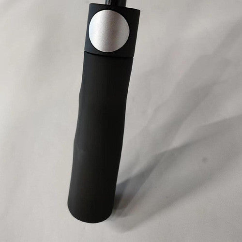 Close-up of Compass umbrella auto-open button and rubber grip handle