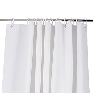Compass plain white PEVA shower curtain hanging in folds from a chrome rail on white plastic rings