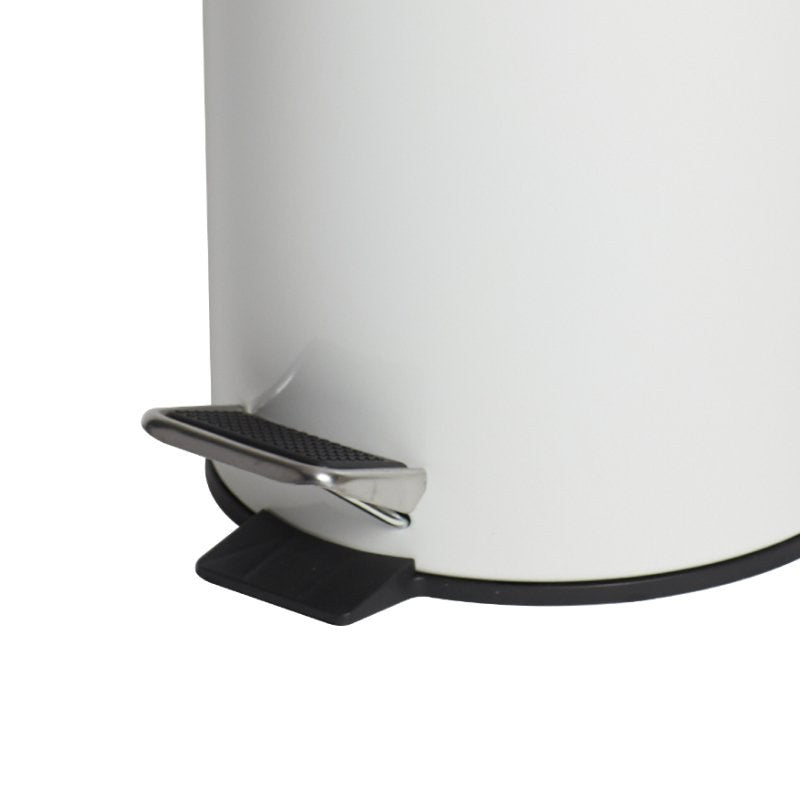 Close view of the base of the Compass white pedal bin showing the chrome foot pedal with a ribbed tread over a black plastic bracket