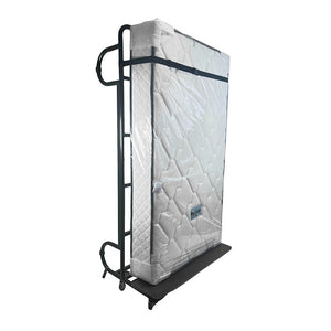 Compass 683122 upright bed standing on its end on wheels, the white quilted mattress strapped inside a black steel frame