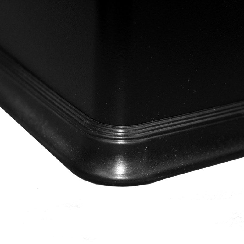 Close view of the base corner of the Compass black rectangular bin showing the rubber rim around the bottom edge