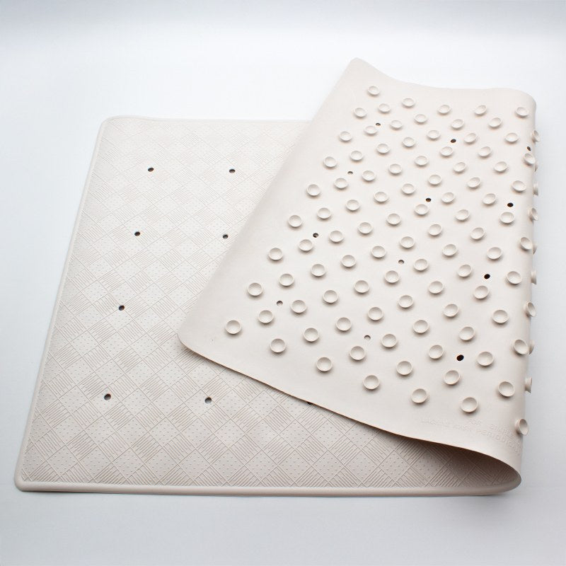 Large Compass rubber bath mat on a light grey surface, half turned over so both the checkerboard top and the cupped underside show
