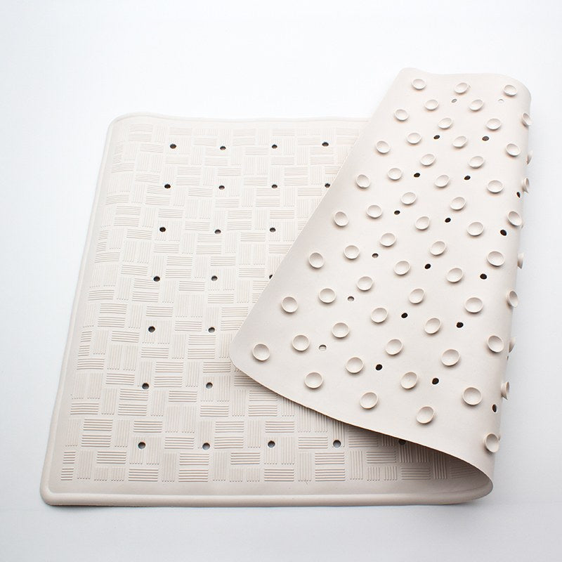Small Compass rubber bath mat on a pale grey surface, folded over at one end to show both faces of the mat