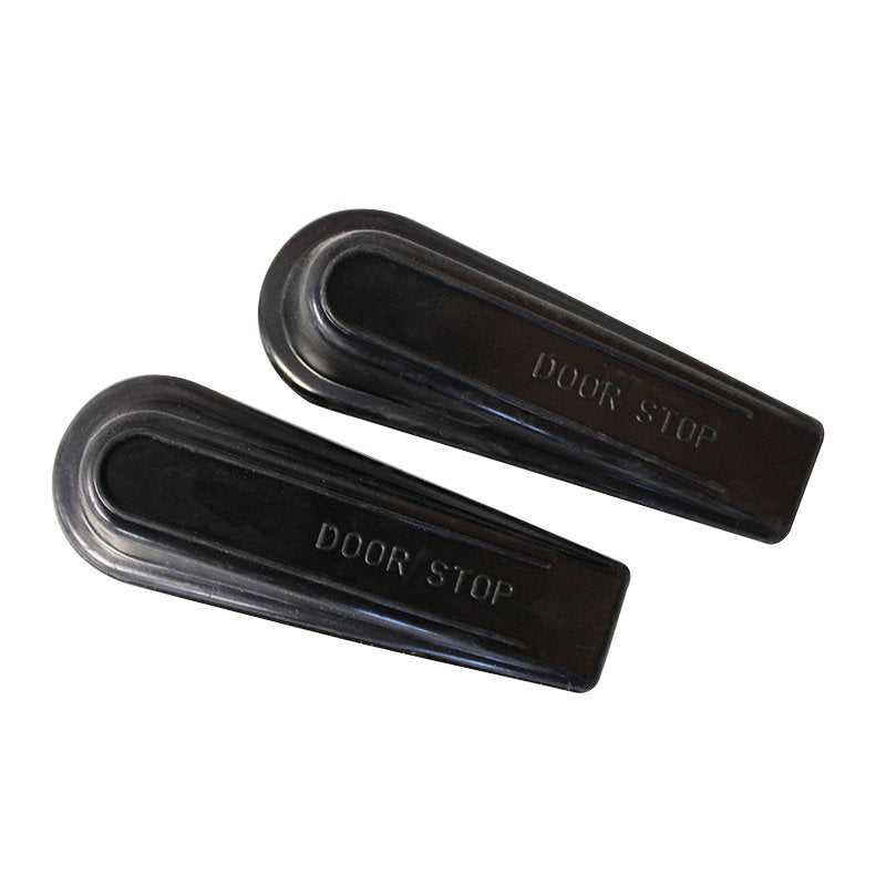 Two black rubber Compass door wedges seen from above, each with the words DOOR STOP moulded into the top surface