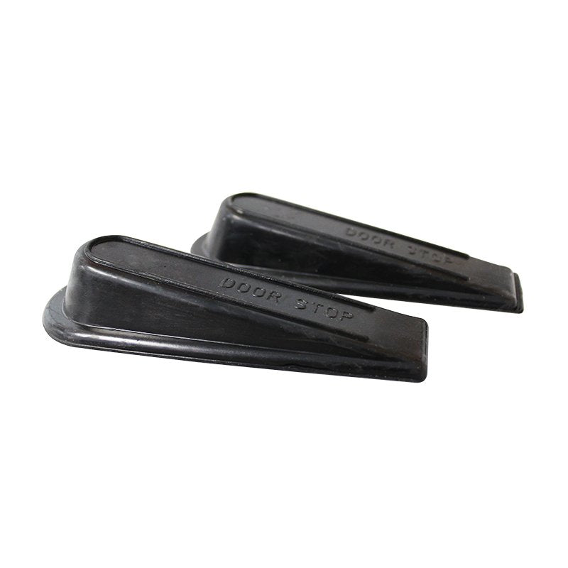 Side view of the two black rubber door wedges showing the slope and the flat lip at the thick end