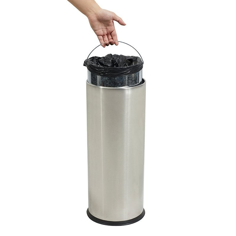 A hand pulling the galvanised liner out of the Compass slim tidy bin by its wire handle with a black bag inside