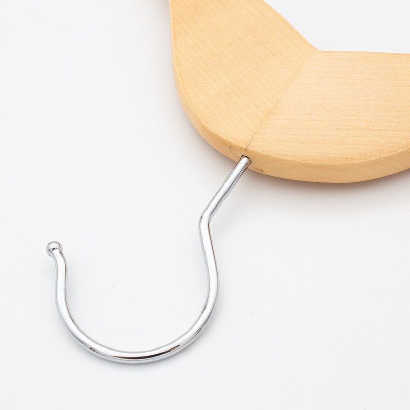 Close view of the chrome hook on the Compass clip hanger, with a curled tip, rising from the light wood crown