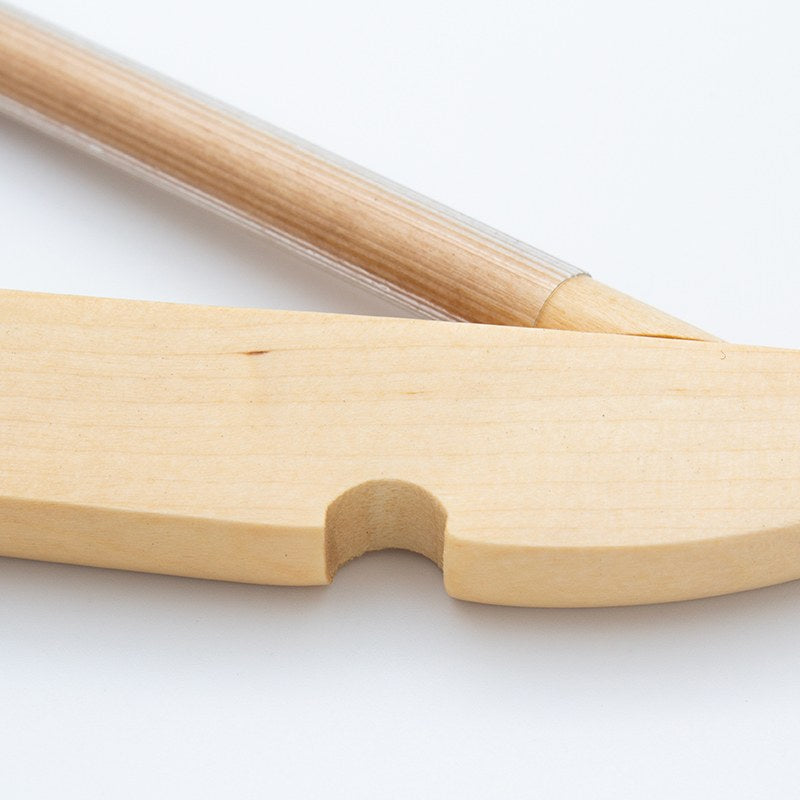 Close view of a light wood shoulder end of the Compass hanger with a notch for garment loops and the covered rod below