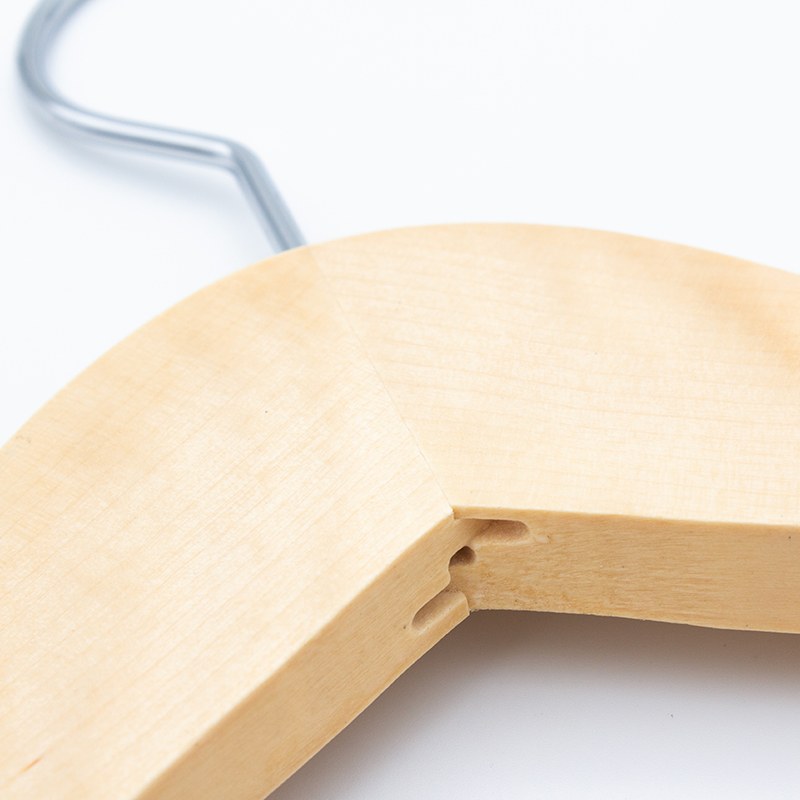 Close view of the centre joint where the two light wood shoulders of the Compass hanger meet below the hook