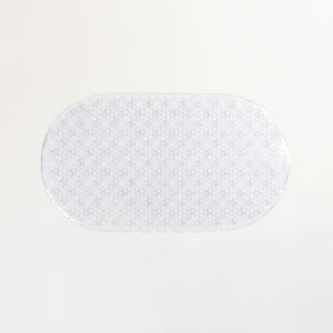 Compass 675015 transparent PVC bath mat, a clear oval with a textured pattern, lying flat on a pale grey background