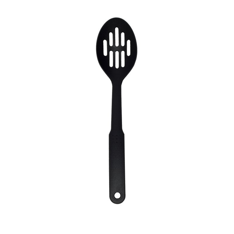 Connoisseur black slotted spoon standing upright on white, oval bowl with two rows of long slots and a hanging hole in the handle
