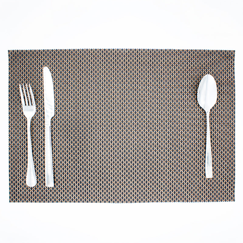 Corner of the brown and black placemat close up, with tan and black strands crossing in a basket weave