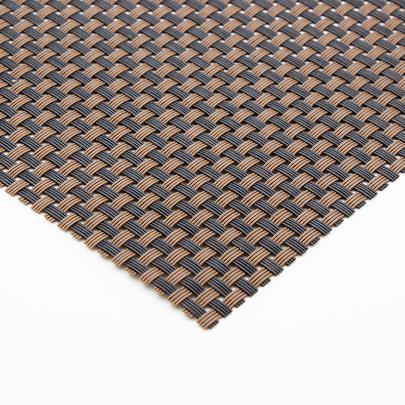 Brown and black woven placemat curled over at one end to show how thin and flexible it is