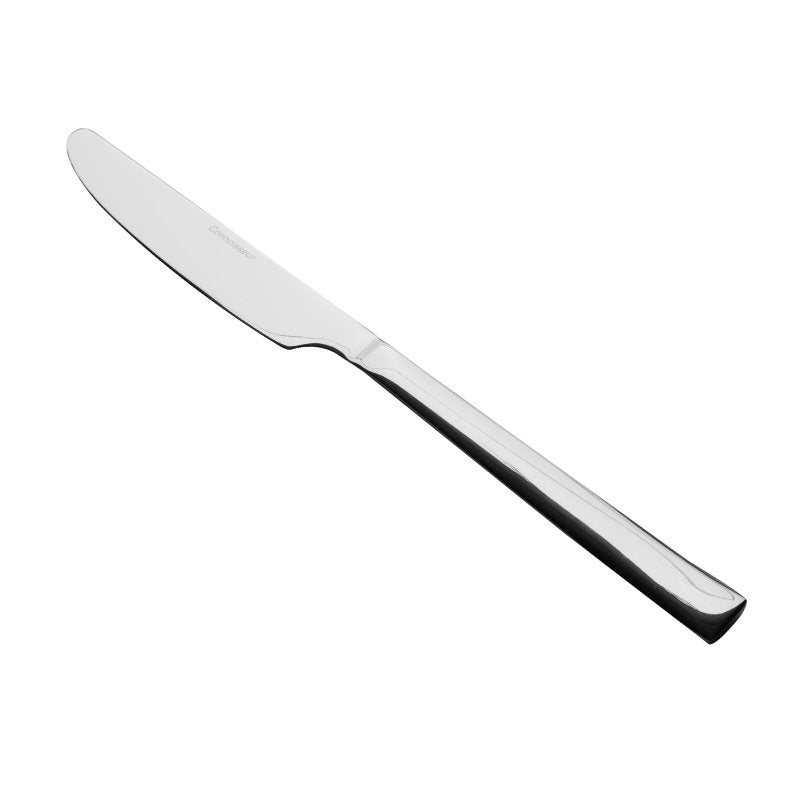 Connoisseur Edge knife on white, rounded blade at the upper left, a stepped bolster and a flat squared handle