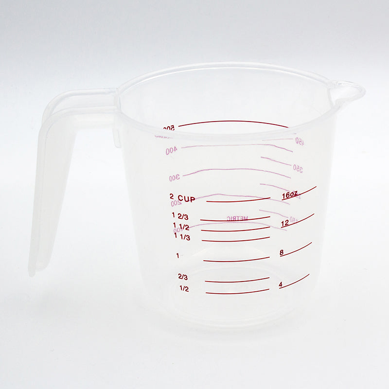 Back of the clear measuring jug showing the red cup scale up to 2 cups and the ounce scale up to 16