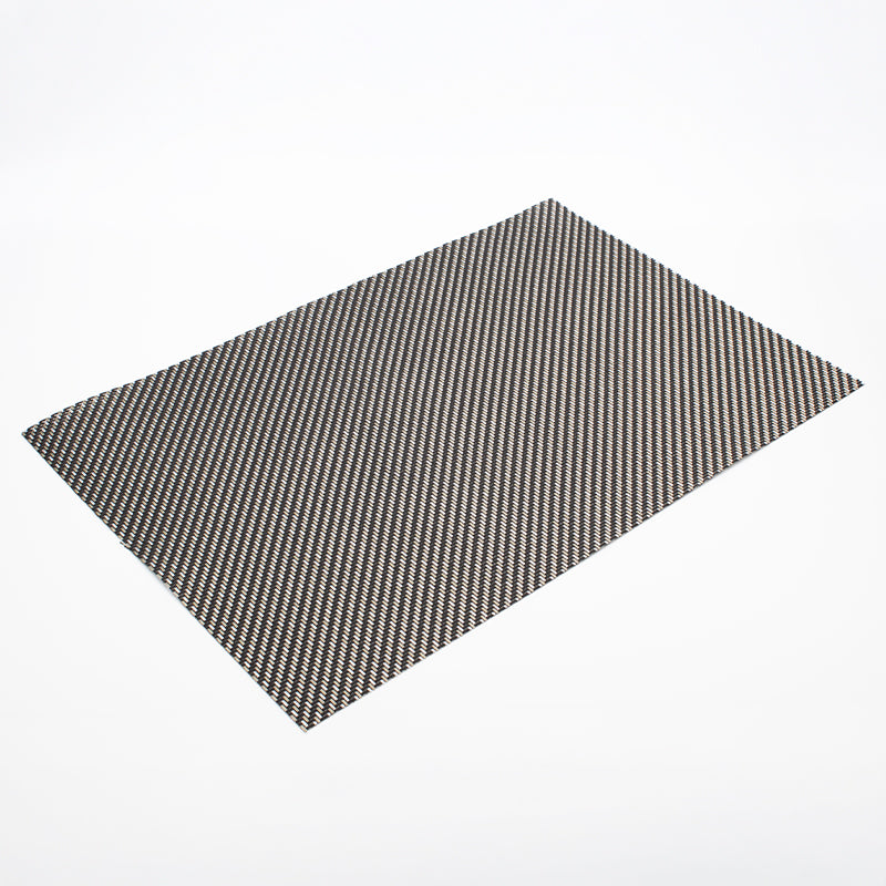 Corner of the metallic placemat close up, black, silver and cream strands running diagonally