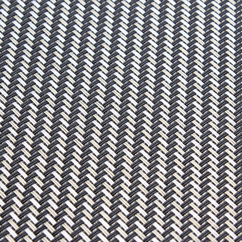 Metallic woven placemat rolled up at one end to show its thin flexible weave