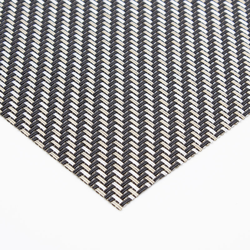 Metallic placemat from above with a fork and knife on the left and a spoon on the right