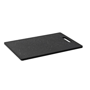 Connoisseur Midnight black plastic chopping board with a speckled finish and a slot handle, lying flat at an angle