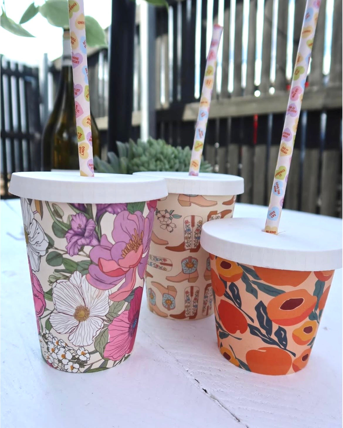Home compostable paper cold lid shown with a paper straw through the centre hole
