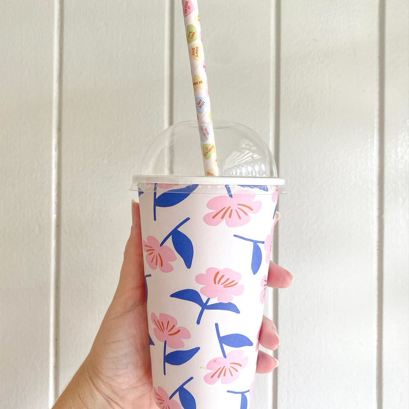 Cold takeaway cup fitted with a clear dome lid and paper straw