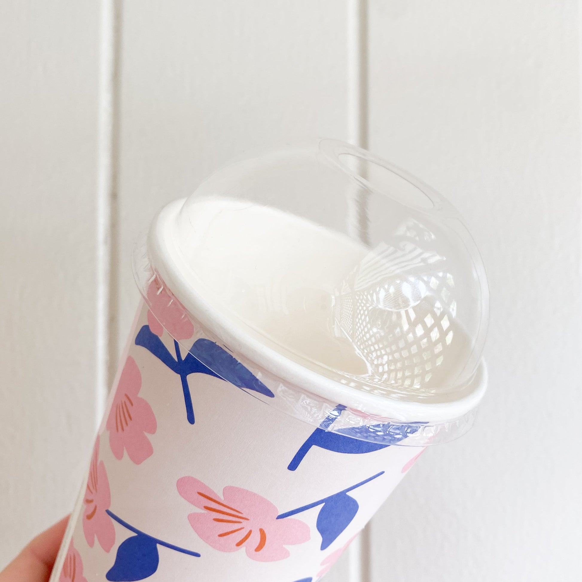 Clear dome lid with straw hole on a juice cup showing topping space under the dome
