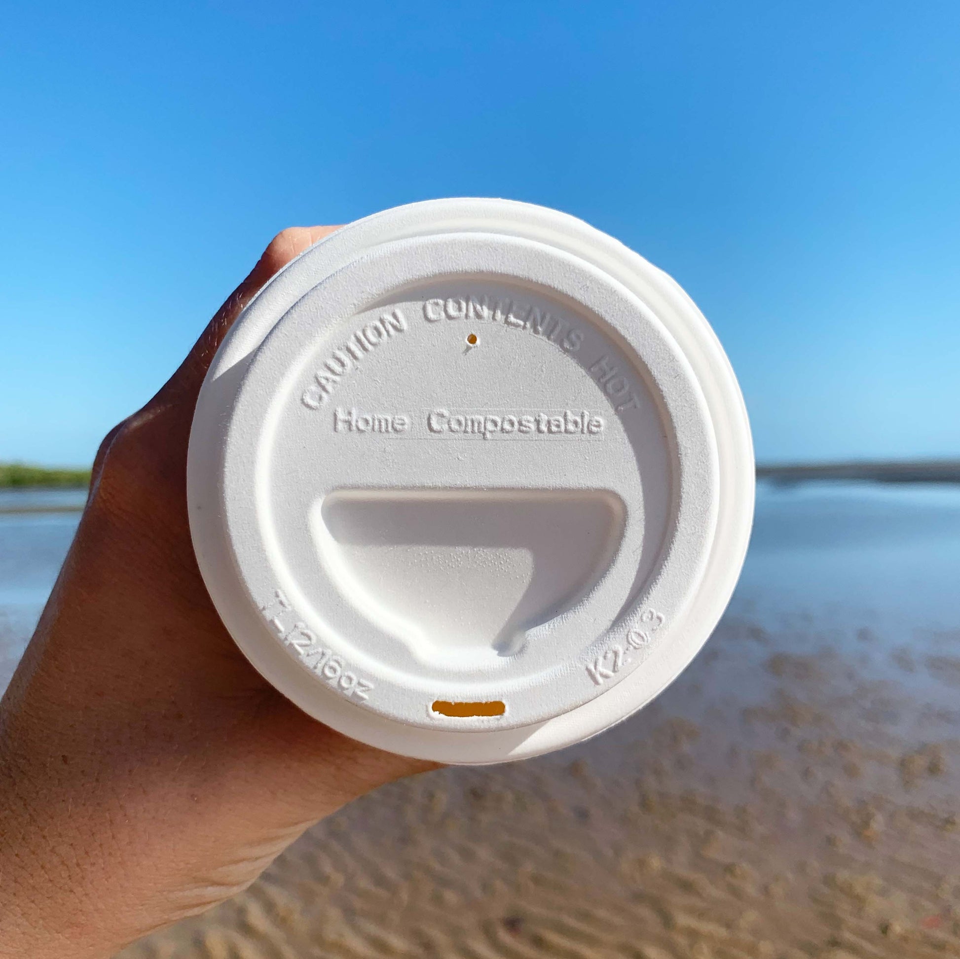 Sugarcane home compostable hot lid fitted to a takeaway coffee cup