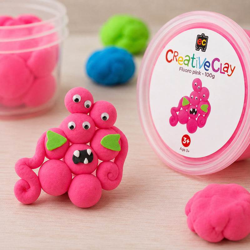 Completed pink clay creature positioned beside the CreativeClay Fluoro Pink 100g container. Additional clay pieces and colourful background elements showcase the product's vibrant appearance and suitability for educational crafts, sensory activities and creative modelling.