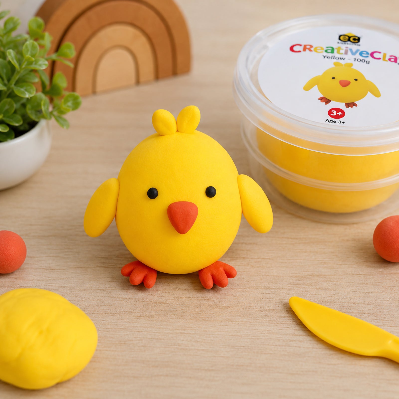Finished yellow chick sculpture created from CreativeClay with detailed wings, beak and feet. The image demonstrates the clay's ability to hold shape while producing fun and engaging character models suitable for children's creative projects.