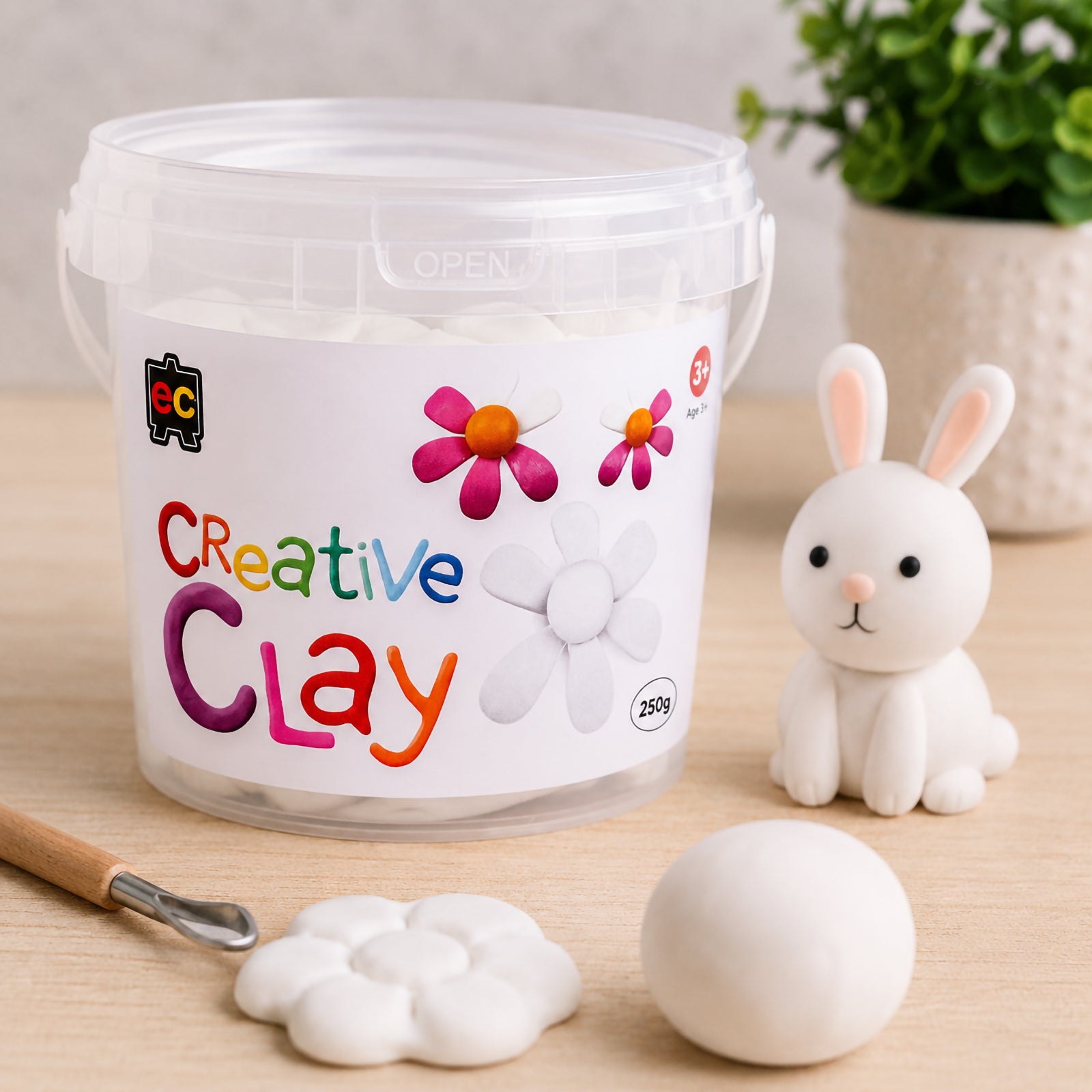 CreativeClay White 250g tub showcased alongside a completed rabbit sculpture, flower model and clay ball. The image emphasises the generous quantity of clay available for larger projects while highlighting the smooth finish and sculpting versatility of the product.
