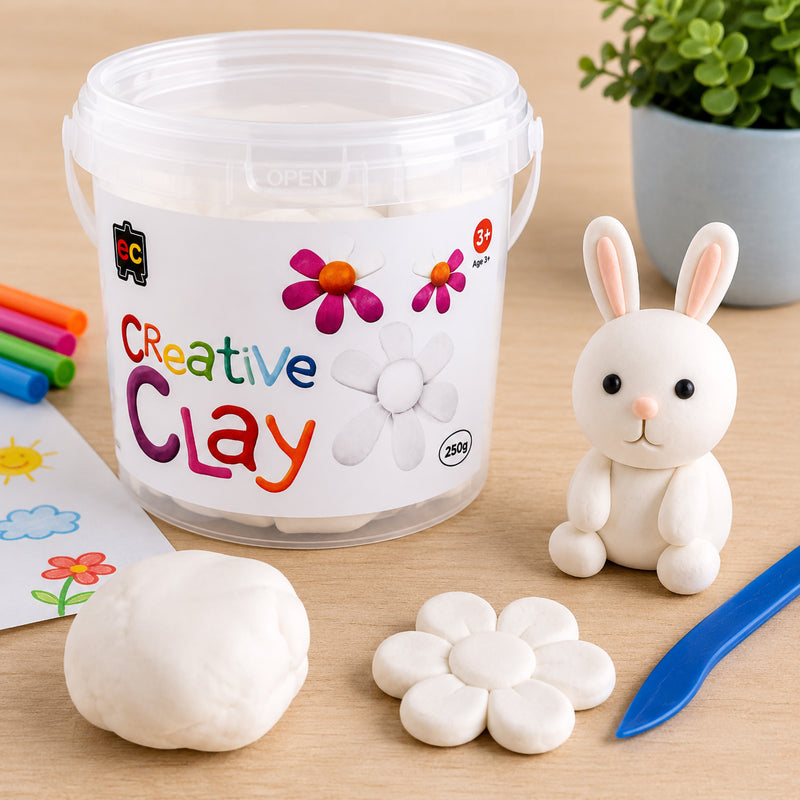 Educational Colours CreativeClay White 250g tub displayed with a white rabbit model, flower sculpture, sculpting tool and clay sample. The scene highlights the clay's smooth texture, bright white finish and suitability for imaginative craft projects, modelling activities and educational learning environments.