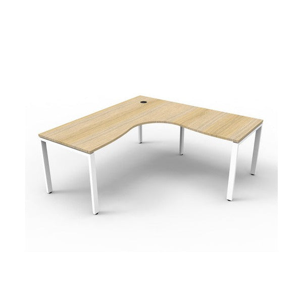 Rapidline Deluxe Infinity corner workstation, Natural Oak top on a white satin profile leg base, wider three quarter view with cable hole visible