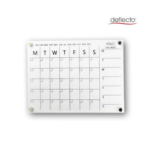 Deflecto A3 acrylic wall planner on a white wall with four round magnetic fixings at the corners, showing the printed month tick row from January to December, the Monday to Sunday monthly grid and the This Week column.