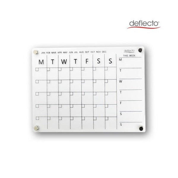 Deflecto A4 acrylic wall planner on a white wall with four round magnetic fixings at the corners, showing the printed month tick row from January to December, the Monday to Sunday monthly grid and the This Week column.